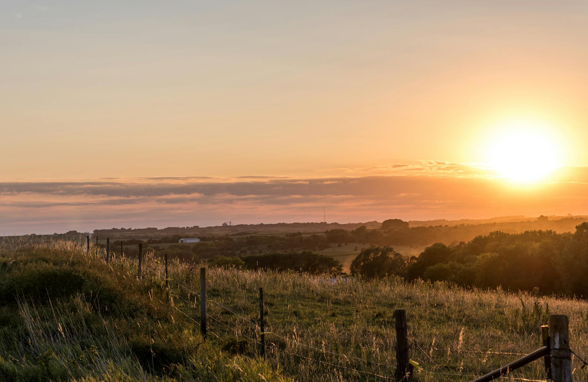 Sunrise over rural Nebraska landscape with rolling fields